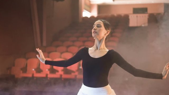 Ballerina dancing on the stage of the theatre. Steadicam. Slow motion. HD.
