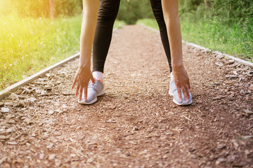 Cropped shot of woman runner stretching 