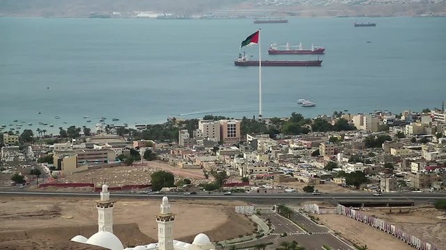 Panorama of Aqaba city in Jordan and seacoast of Eilat city in Israel. View from mountain in Aqaba city in Jordan. Two city and two country in one video clip