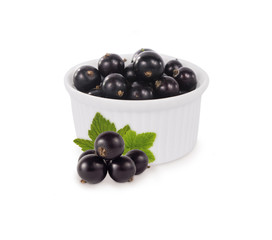 Bowl with blackcurrants isolated on white background. Ripe currants close-up. Background berry. Sweet and juicy berry with copy space for text. Antioxidant and the best berry, a source of vitamin C