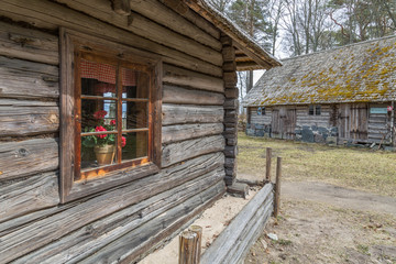 Agricultural buildings of wood and stone with thatched roofs 