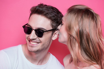 Obraz premium Stylish young couple in love posing together isolated on pink