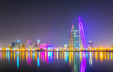 Skyline of Manama dominated by the World trade Center building during night, Bahrain.