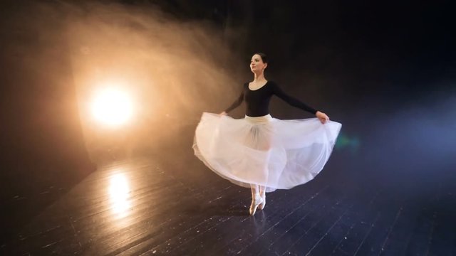 Ballerina flying around in the long tutu dress. Dolly. Slow motion. HD.