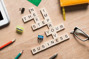 Conceptual business keywords on table with elements of game making crossword