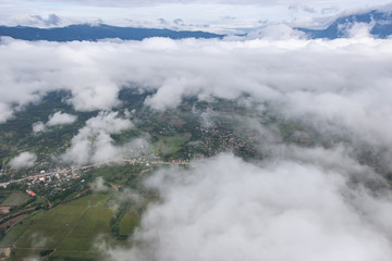 Aerial View of Village landscape and River over Clouds in Chiangdao Thailand

