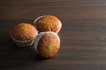 Banana cupcake on brown wooden table / Still life and selective focus and space for text..
