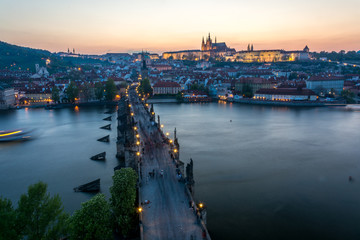Tourists on Charles Bridge in Prague after sunset