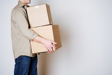 Moving: Anonymous Man Carrying Cardboard Moving Boxes