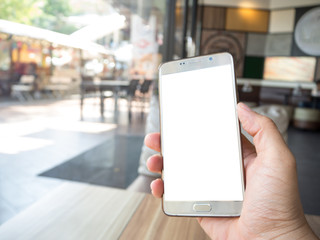 Man hand holding touch screen smart phone with white blank empty screen (ISOLATED), blurred fast food restaurant for background.