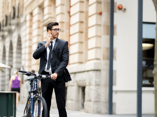 Young businessmen with a bike