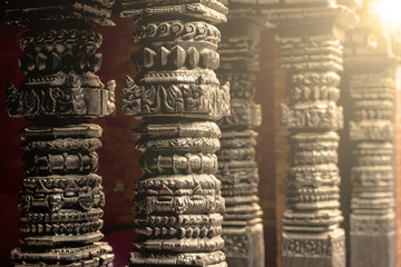 abstract background of woodcraft pillars close up on the nearest with lens flare and some copy space, ancient concept