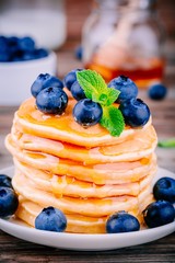 Healthy breakfast: pancakes with blueberries and honey syrup