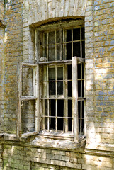 Old broken window in a brick house