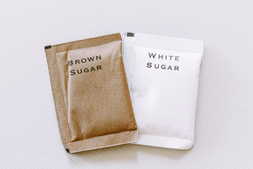 White and brown sugar bag on white background