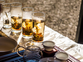herbal flower hot tea on transparent glass in process