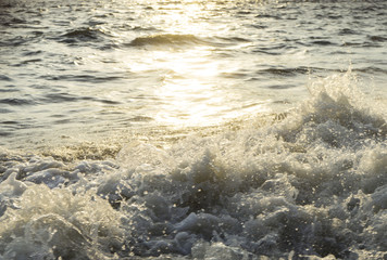 Water surface with ripples and sunlight reflections
