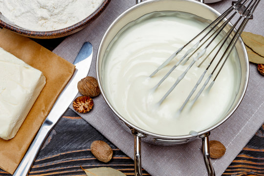 Bechamel Sauce In A Pan And Ingredients