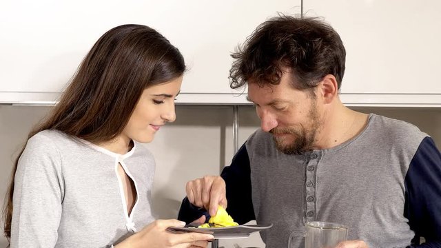 Man eating and spitting bad omelette prepared by lovely girlfriend funny closeup