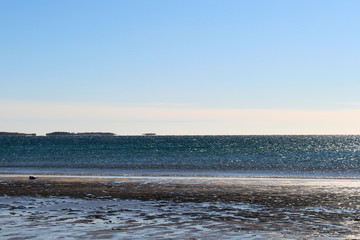 Empty Old Orchard Beach in winter.  Frozen ocean.