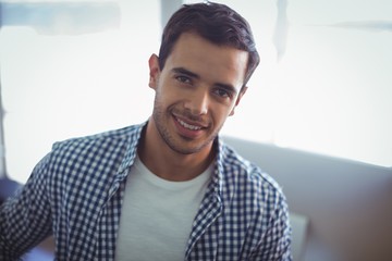 Smiling male graphic designer in office