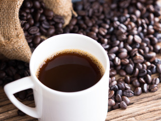 black roasted coffee beans on aged wood