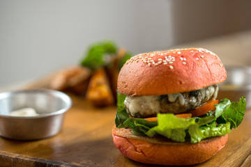 Burger in a pink bun and juicy chop
