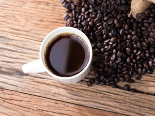 black roasted coffee beans on aged wood