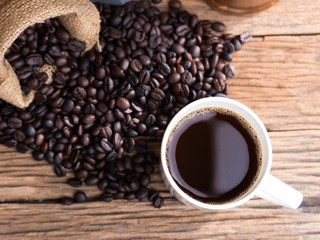 black roasted coffee beans on aged wood