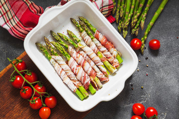 Baked green asparagus wrapped with bacon