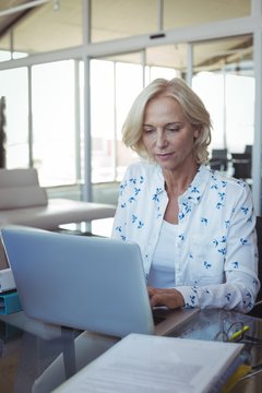 Focused entrepreneur working on laptop at office