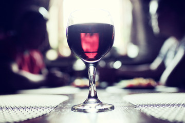 Serving a glass of red wine in a restaurant