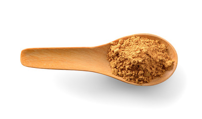 Cinnamon powder in wood spoon on white background