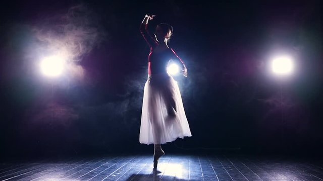 Ballerina's silhouette dancing. Slow motion. No face. HD.