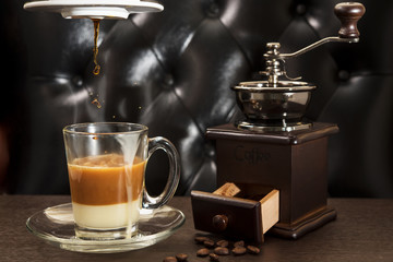 Old coffee grinder and coffee cup on wooden table. Vietnamese coffee. Sweetened Condensed Milk.