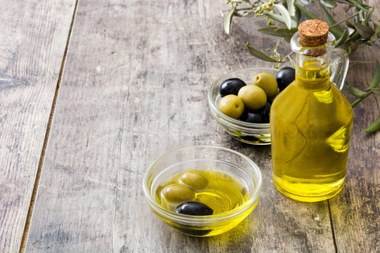 Virgin olive oil in a crystal bottle on wooden background
