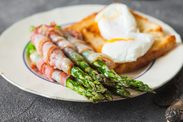 Baked green asparagus wrapped with bacon