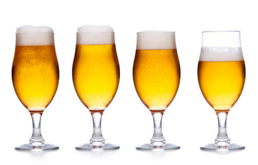 .set of glass of cold light beer with foam on white .