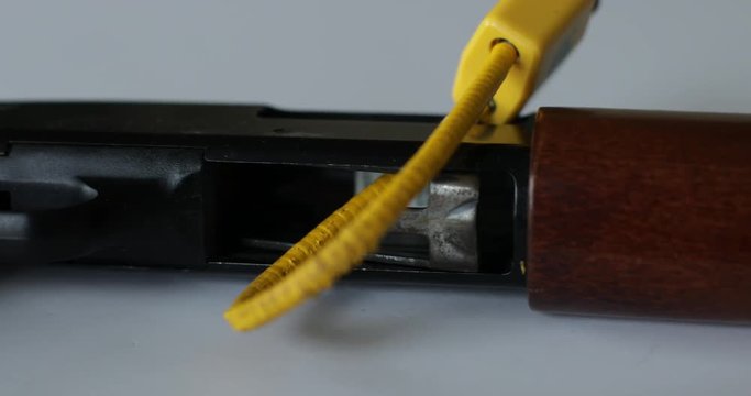A trigger lock on a shotgun for safety