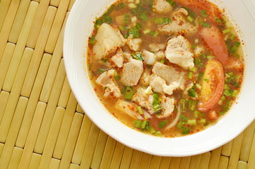 hot and spicy pork bone with tamarind and Thai herbs soup on bowl