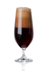 dark beer with foam on white .