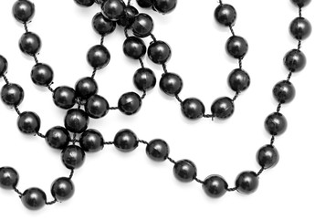 Black beads on a white background