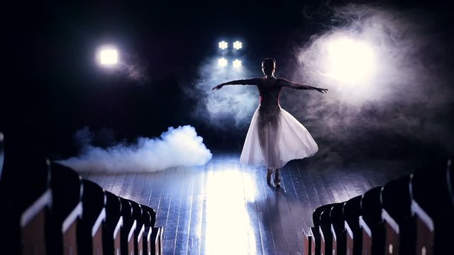 Ballerina girl flying over the stage. Silhouette. Slow motion. HD.