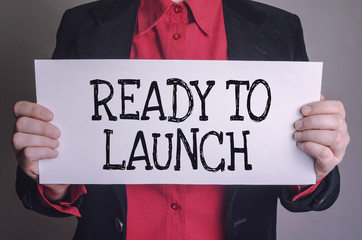 Message Ready to launch on white card hold by businessman