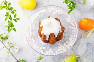 Traditional Easter cake with colored eggs. Marble background. Top view.