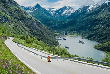 Fjord Road in Norway:  A two-lane road narrows as it descends beside Geirangerfjord in the...