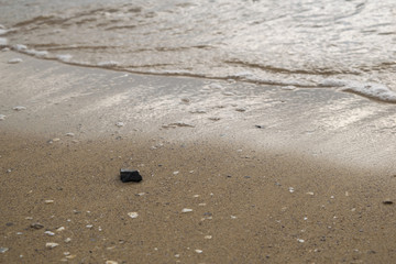 Black stone on the beach
