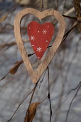 stylish wooden heart Closeup on a branch in winter