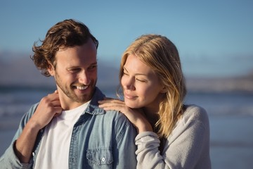 Fototapeta premium Young couple standing at beach