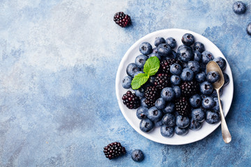 Fresh blueberry and blackberry berries. Top view. Copy space.